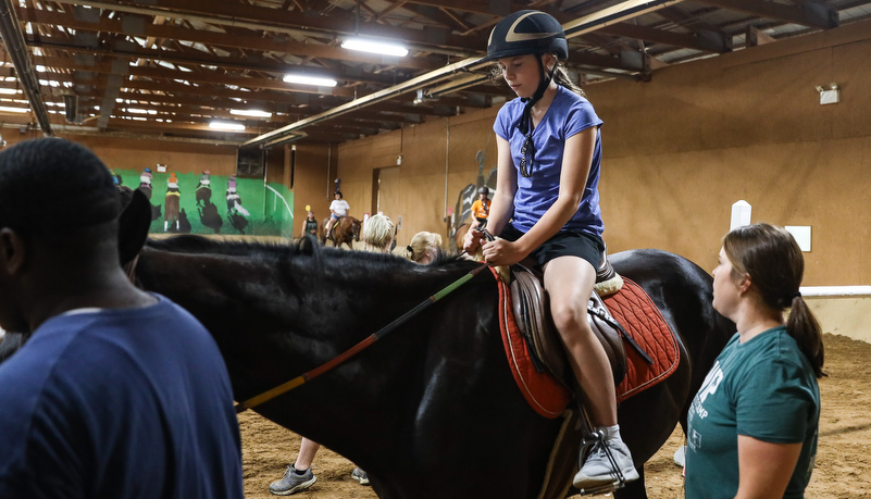 Camper riding a horse