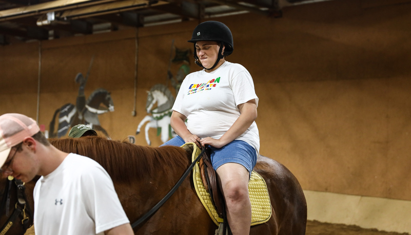 Camper riding a horse