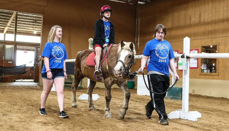 Camper riding a horse