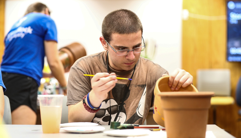 Camper painting a flower pot