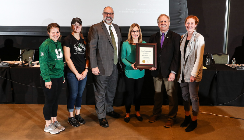 President Behre, representatives from the Field Hockey Team, and Trusstee Jeff Smith