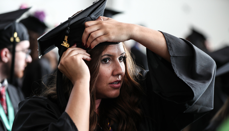 Woman adjusts her cap