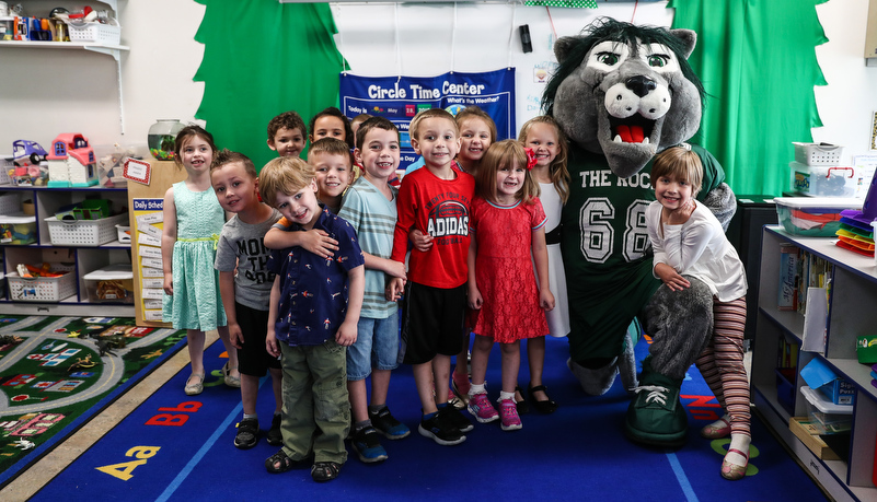 Pre-school children pose with Rocky