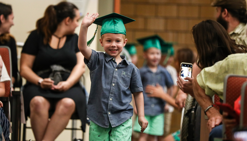 Boy enters waving