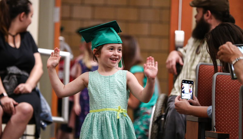 Girl enters waving