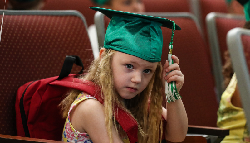 Girl adjusts his cap