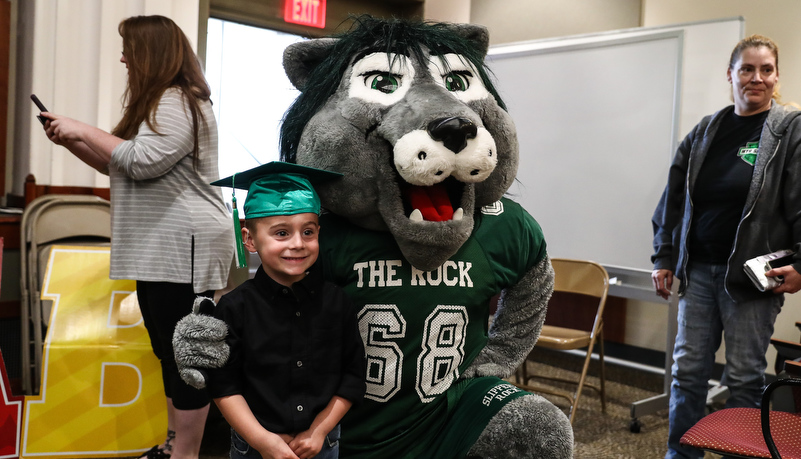 Pre-schooler poses with Rocky