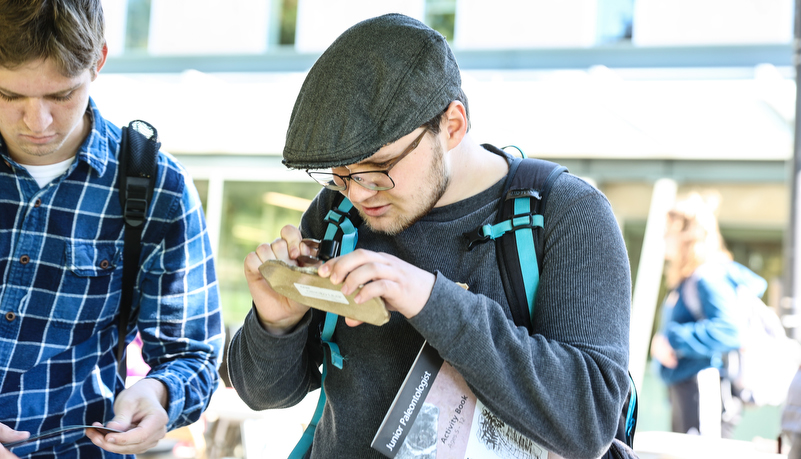 Student examining a fossil