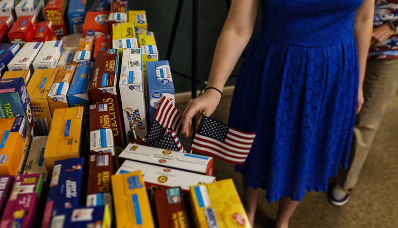 faculty member placing an American flag in a vase