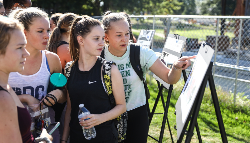 students looking at renderings of the building