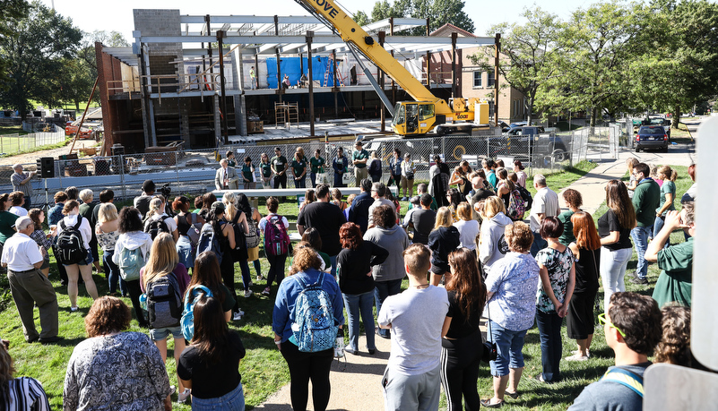 the crowd waits to sign the beam