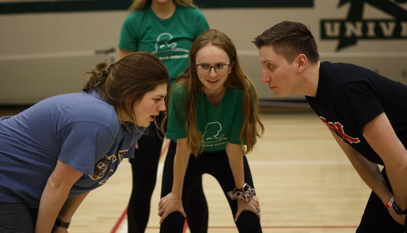 Three students facing off before a game starts