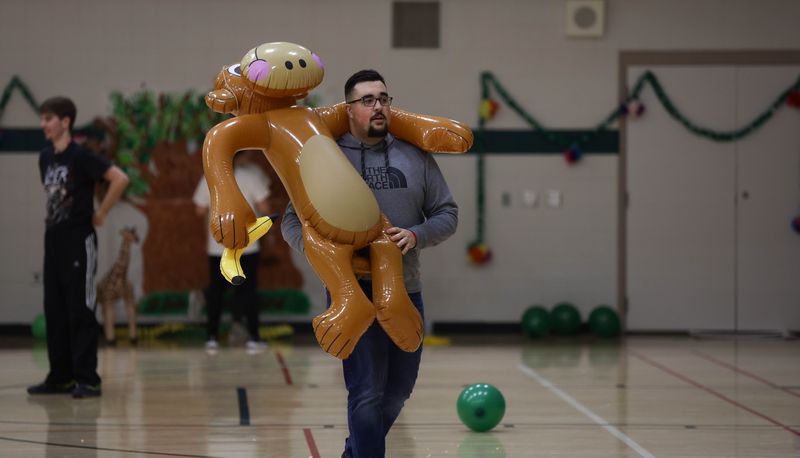 Guy walking with big inflatable monkey