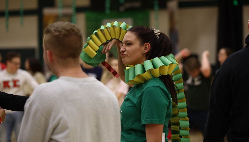 Girl wearing a colorful paper-chain snake around her neck