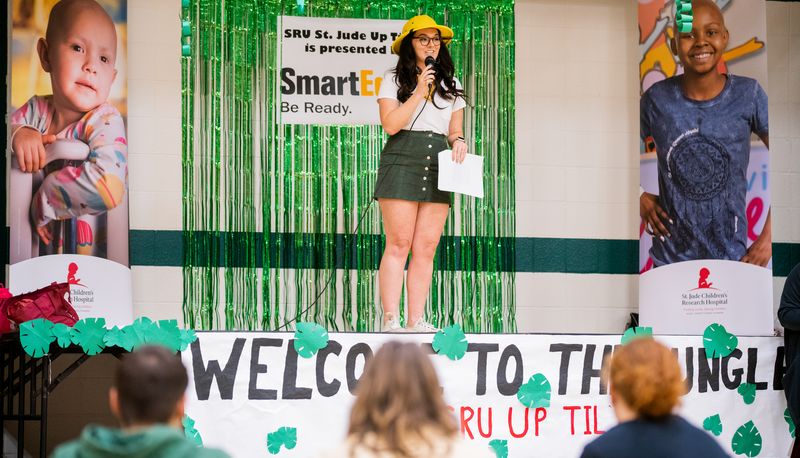 Female student presenting on-stage for St Judes