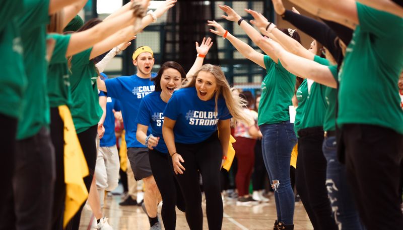 Students running through 'human tunnel' of arms