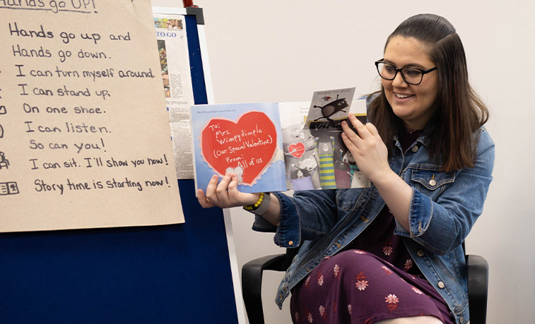 Student reading to children