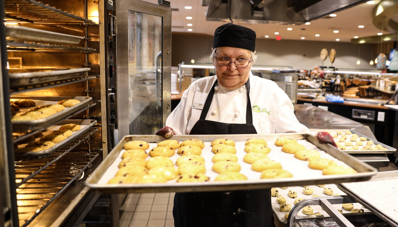 Woman taking cookies out of the oven