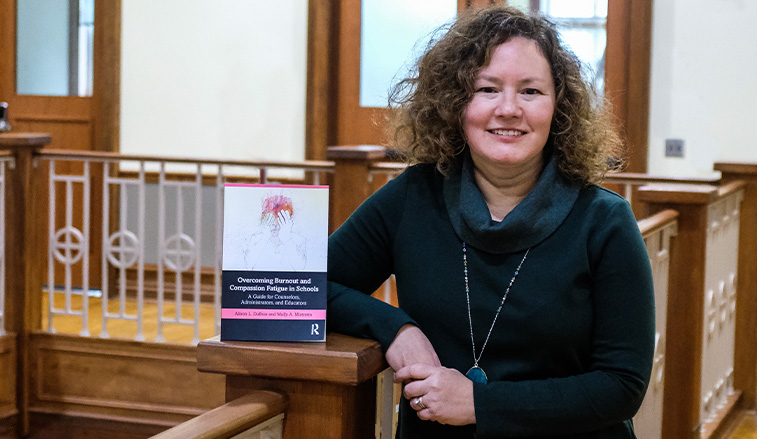 Molly Mistretta with the book she authored