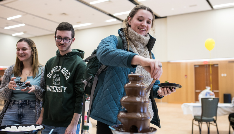 Students making treats in a chocolate fountain