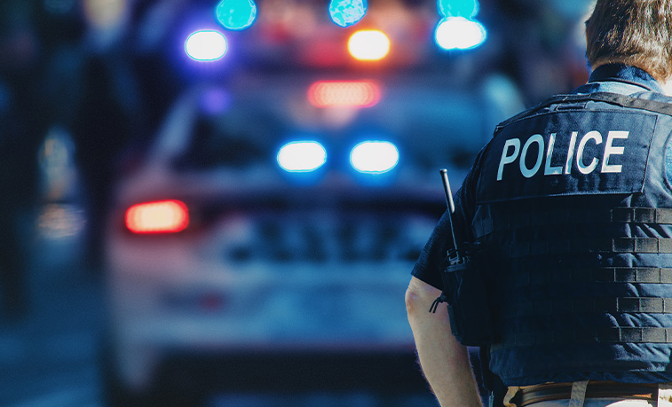 Police car with lights on and a officer