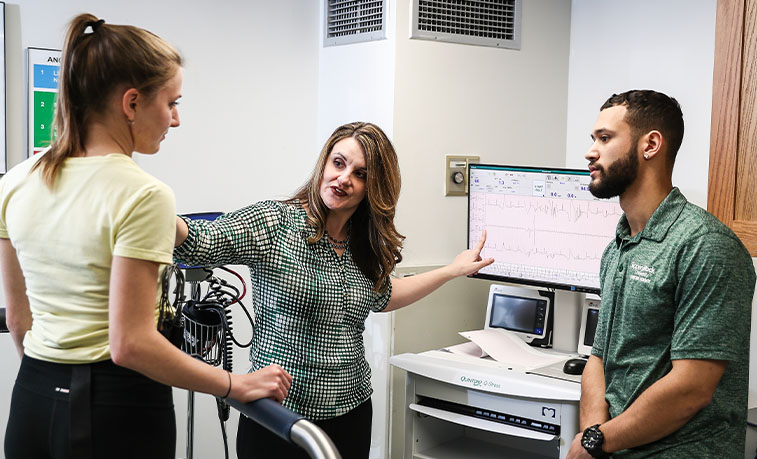 students working with a professor