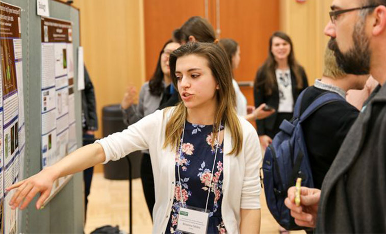 Student presenting to a professor