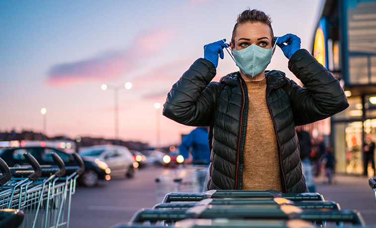 Woman putting on a facemask