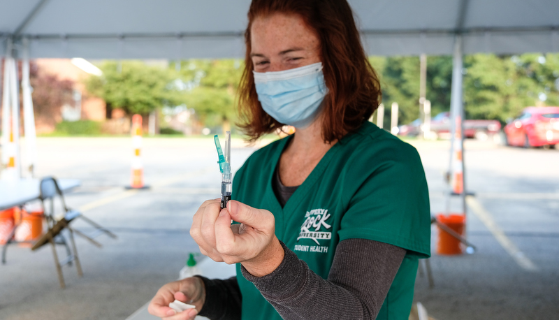 Health center worker with a vaccine