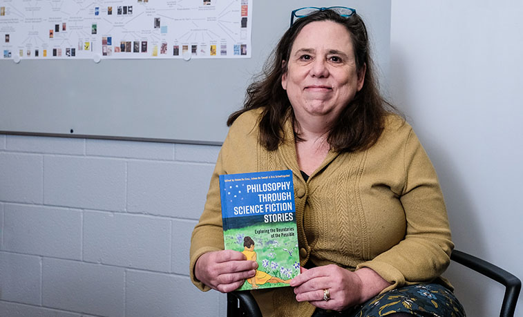 Professor holding the book