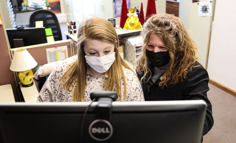 Student working with a staff member