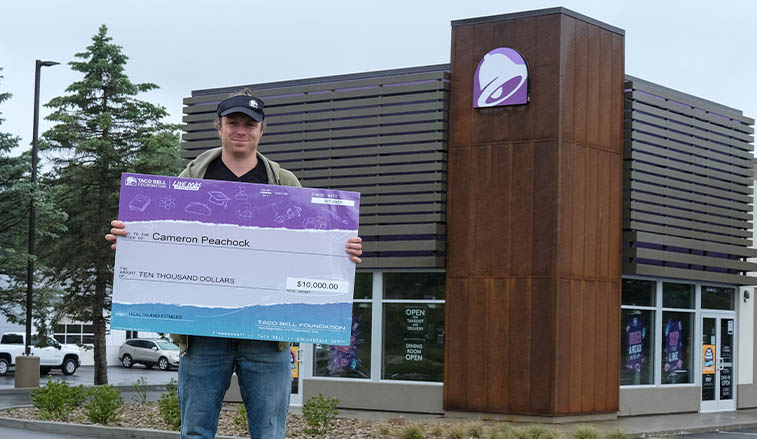 Student holding his scholarshiop check