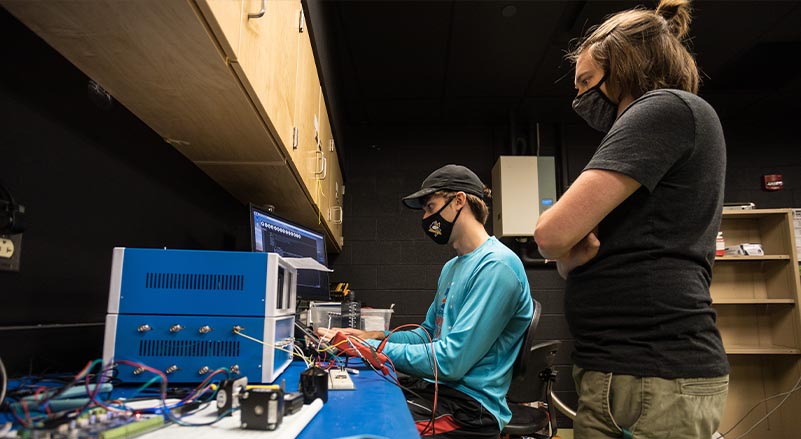 students working out the electronics