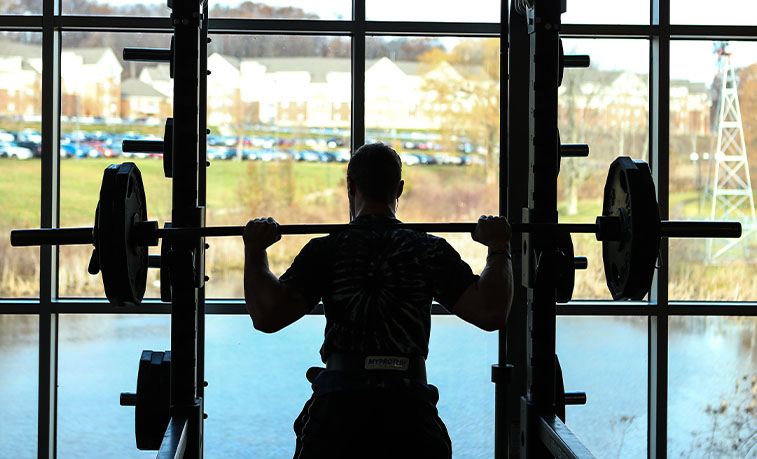 Student lifting weights