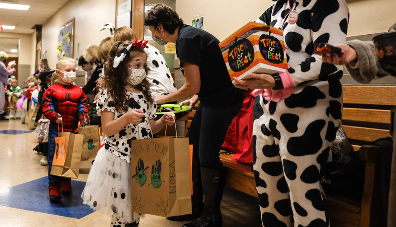 Pre=school students trick or treating in the education building