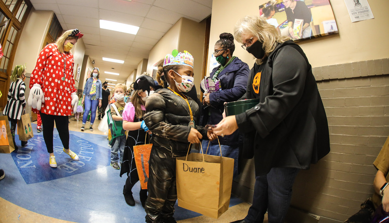 Pre=school students trick or treating in the education building