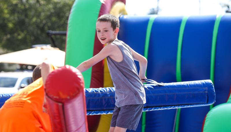 Kid playing on the bouncy house