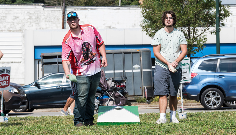 Two men playing cornhole