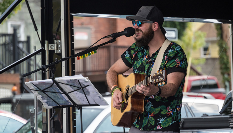 Man playing guitar and singing to a crowd