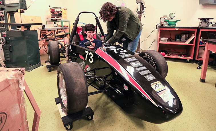 Students working on a race car