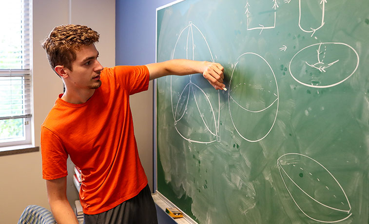 Student working on the black board