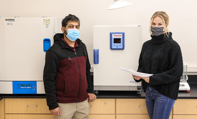 Student and professor in a lab