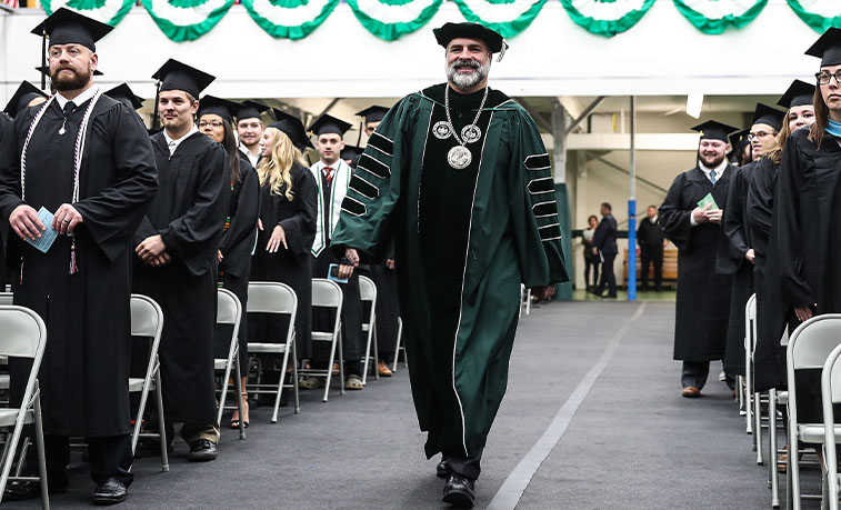 President Behre entering graduation