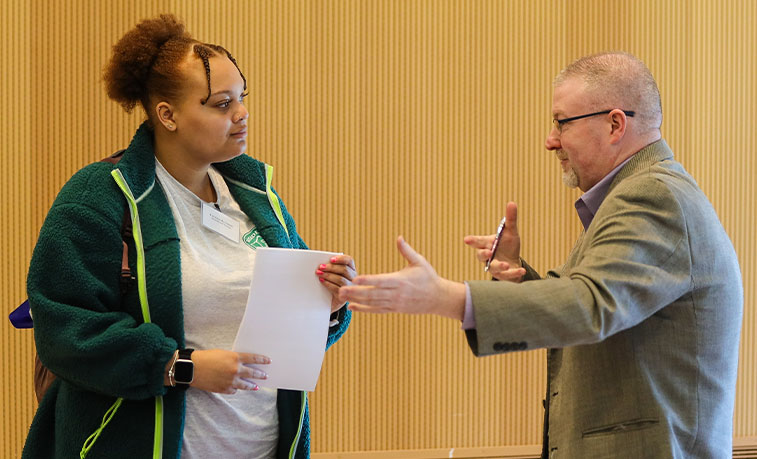 Student talking to an employer