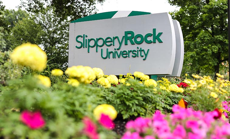 Campus sign and flowers