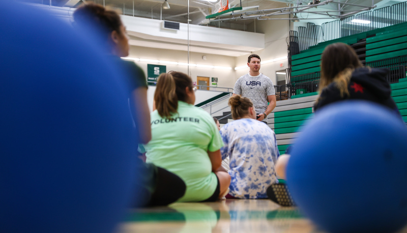 Students listening to coach