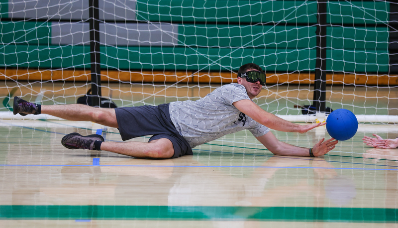 Student diving for a ball