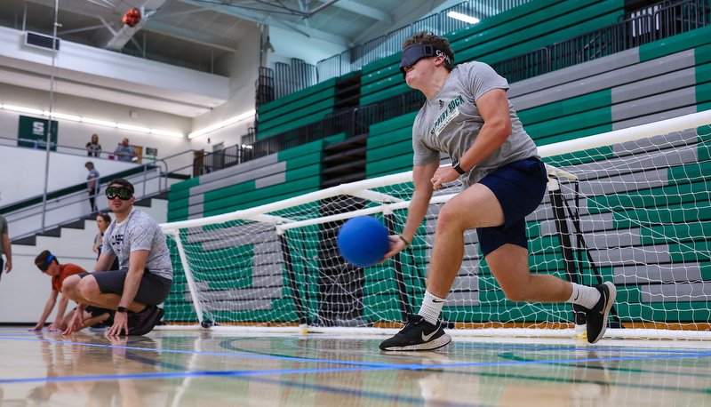 Students blindly rolling balls