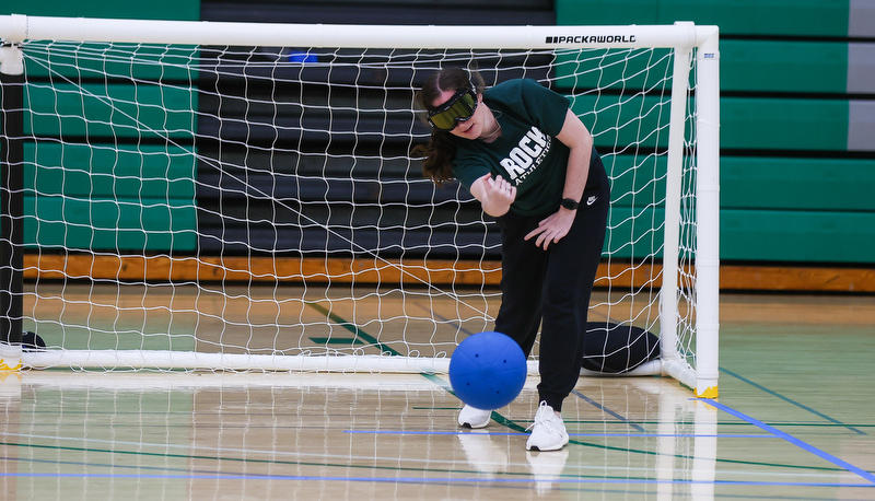 Student rolling ball away from goal