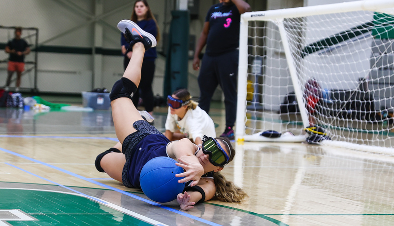 Student making a diving stop for ball